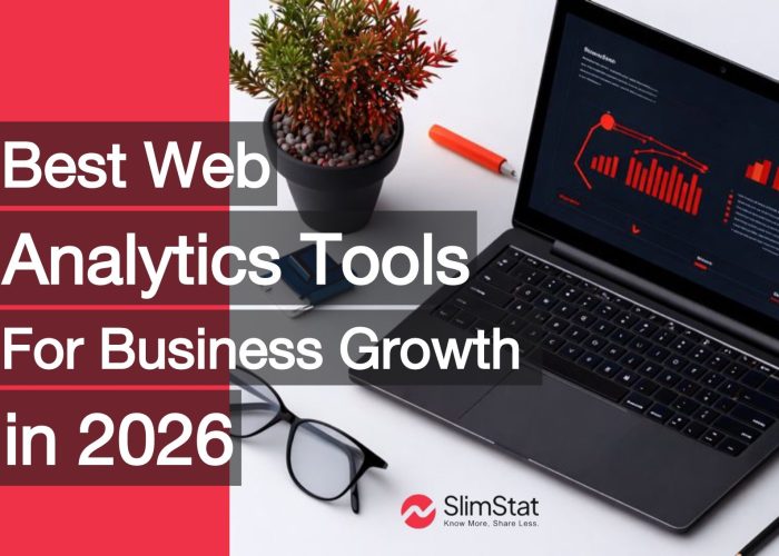 Laptop on a modern desk displaying red analytics charts and graphs, with office items like plants, glasses, and coffee, representing web analytics tools for business growth in 2026.